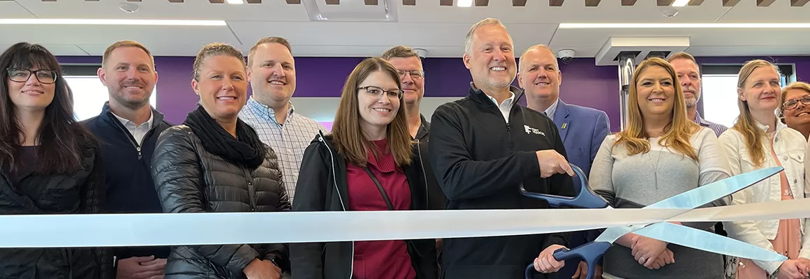 people cutting ribbon at new branch opening
